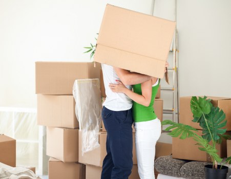 Removal team handling furniture in a Paddington street with tight access